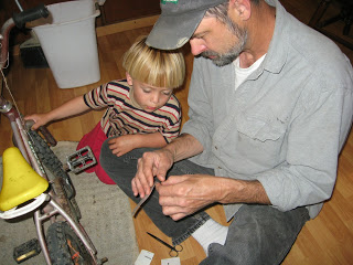 Two Mechanics assess the situation with the bike 